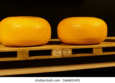 Round Pieces Of Cheese On EUR Pallet In A Dutch Cheese Store