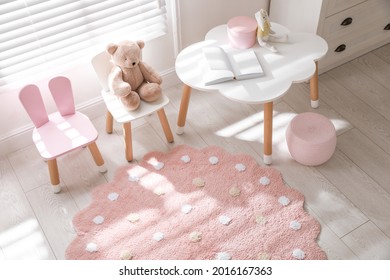 Round Pink Rug On Floor In Children's Room, Above View