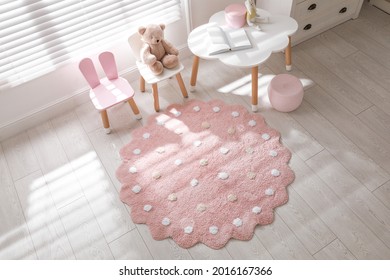 Round Pink Rug On Floor In Children's Room, Above View