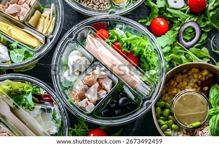 Round plastic boxes with pre-packaged vegetable salads. Convenience food
