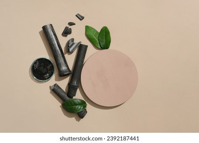 A round platform is placed on a base with bamboo charcoal and green tea leaves. Bamboo charcoal powder is stored in a petri dish. Free space for cosmetic display and advertising.