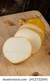 round processed cheese on the table, sausage cheese made from cow's milk