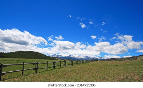 Round rail fence under blue sky in the Bighorn Mountain range of  Rocky Mountains in Wyoming USA - Shutterstock ID 2014911305