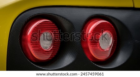Round red brake lights on a car