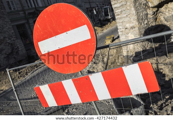 Round red\
sign No Entry hanging on urban road\
barrier