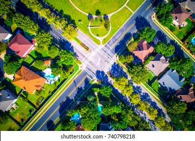 Round Rock , Texas , USA Suburb Growing Outside Of Austin High Aerial Drone View Green End Of Summer Colorful Morning Millions Of Homes Neighborhood Suburbia Straight Down 4 Way Stop