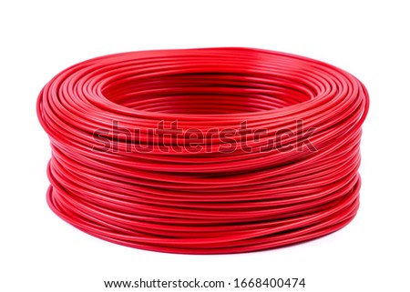 Round roll of red electrical single core cable isolated white background
