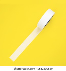 Round Roll Of White Duct Tape, Adhesive Tape On A Yellow Background. View From Above