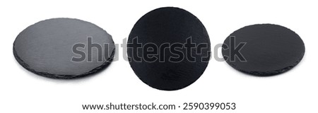 Round rustic black slate stone plate, isolated on white background.