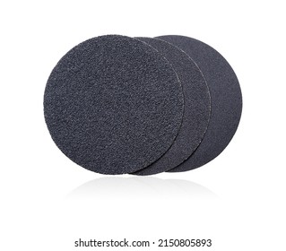 Round sanding discs. A set of round sandpaper discs with different types of grit on Velcro for a sander isolated on a white background. A series of tools. Round abrasive paper.