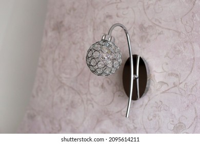 Round Sconce Made Of Crystals On Pink Wall