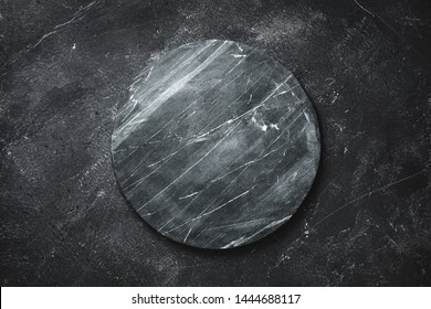 Round Serving Tray Made Of Marble On A Dark Background. The View From The Top. Copy Space