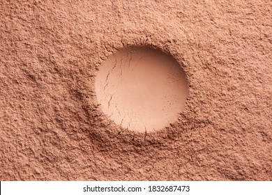 Round shaped loose cosmetic powder textured nude beige background