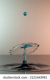 Round Shaped Water Drop Splash With Single Blue Drop Above