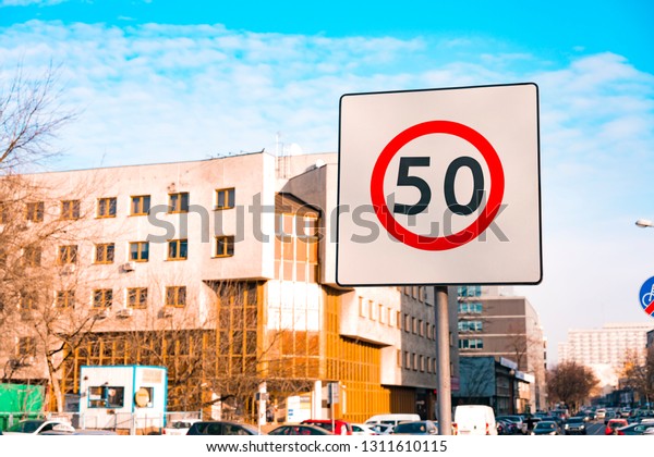 Round sign 50 speed\
limit in the city on the square white background. Polish speed\
limit sign on the road