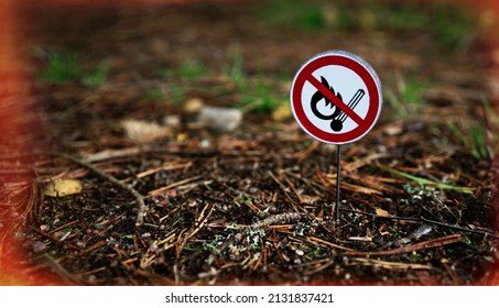 Round sign it is forbidden to use fire in the forest. Danger of fire in the forest area. A match crossed out with a red stripe. Fire safety sign. It is forbidden to build bonfires in the forest. - Shutterstock ID 2131837421