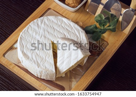 Round soft cheese, with a section cut