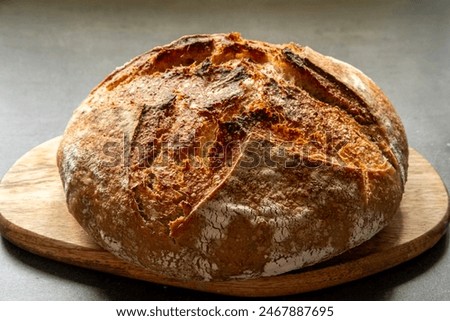 Similar – Image, Stock Photo A round loaf of bread lies on baking paper and is about to go into the oven