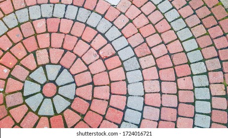 Round Square Area Paved With Red Grey Stones . Concentric Lines Of Road Tiles Cover Top View. Circle Pavement Pattern.