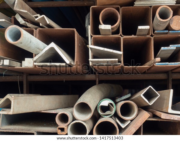 Round and\
square shaped steel pipes on the\
shelves