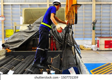 The Round Steel Bar Discharging From Electric Crane Hook And Load Onto The Truck By Truck Driver.