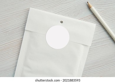 Round Sticker Mockup For Gift, Product Label, Circle Gift Tag, Logo Or Thank You Sticker Mock Up On White Paper Bubble Envelope, Close Up View.