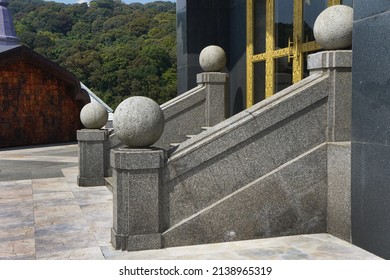 Round Stone On The Pillar Of The Stairway Leading Up To The Building