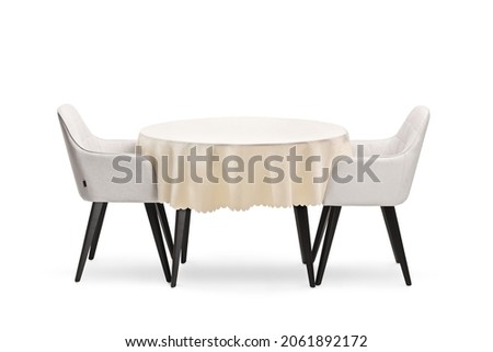 Round table with a cloth and two chairs isolated on white background