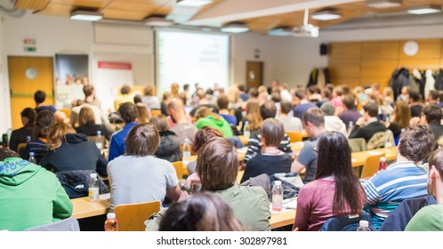 Round table discussion at business and entrepreneurship workshop. Audience at the conference hall. Presentation in lecture hall at university. Participants listening to lecture and making notes. - Shutterstock ID 302897981