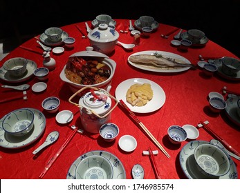 Round Table With Red Cloth And View Of Typical Dinner Table During Family Reunion Dinner On Chinese New Year Eve