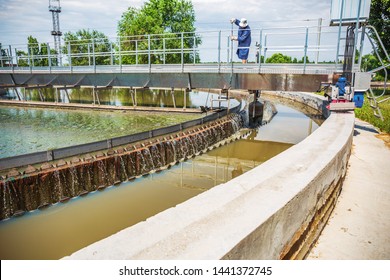 Round Tank And Worker In Wastewater Treatment Plant, Close Up
