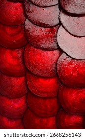 Round textured slices of beetroot. Macro photo of beetroot. Top view. Vertical photo.