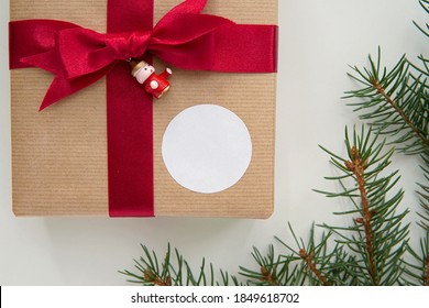 Round Thank You Sticker Mockup For Christmas Gift, Circle Adhesive Label On Kraft Paper Box And Red Ribbon.