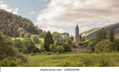 The Round Tower and woodland at Glendalough, Co. Wicklow, Ireland. The Glendalough valley is located in Wicklow Mountains National Park and is home to an Early Medieval monastic settlement.