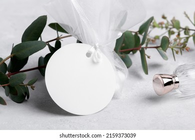 Round white gift tag mockup with eucalyptus leaves on grey background, label tag mockup, Wedding favor tag for souvenir, sign for greeting message close up, element for design - Shutterstock ID 2159373039