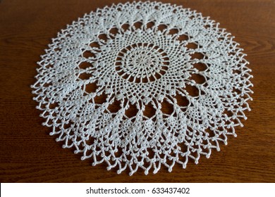 Round White Handmade Crochet Lace Doily On Wooden Table