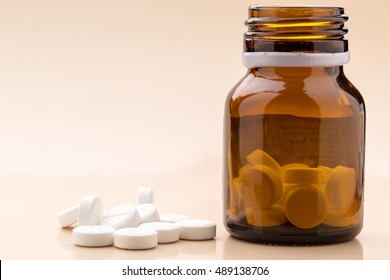 Round White Pills And Glass Pill Bottle