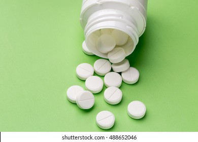 Round White Pills And Plastic Pill Bottle