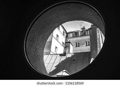 Round window, closeup. View from one window. Small round window with view of the city  