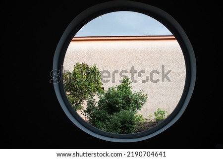 round window tree and house