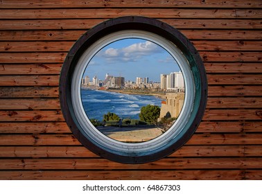 Round window of the wooden house with panoramic view on Tel-Aviv (Israel)