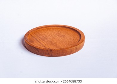 A round wooden coaster made from natural wood, isolated on white background, minimalist product photography