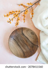 Round Wooden Craft Plate Mockup For Eco, Food Or Beauty Product And Branch With Orange Berries On Pink Background. Top View. Copy Space