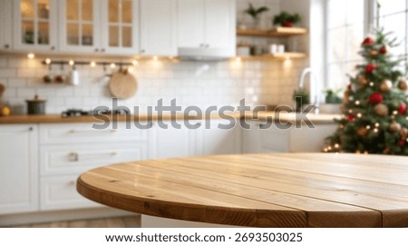 Round wooden table with empty space on a blurred background of a white kitchen interior decorated for christmas with a tree, lights, window, shelves and cabinets