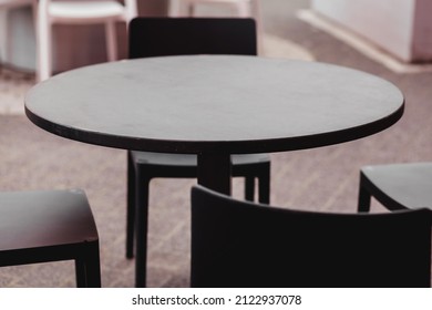 Round wooden table of street restaurant. empty outdoor cafe. no people