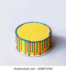 Round Yellow Birthday Cake. Decorative Colored Stains. Top View. White Background. Copy Place