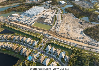 Roundabout intersection construction in North Port, Florida. Development of American road circle with moving traffic cars. Urban circular transportation crossroads