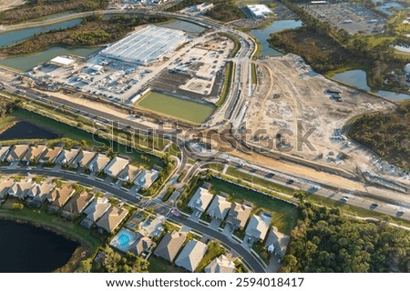 Roundabout intersection construction in North Port, Florida. Development of American road circle with moving traffic cars. Urban circular transportation crossroads