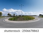 The roundabout road aerial view that newly developed. Summer sunny day. Roundabout on suburban road. Universal road photo. Road in agricultural fields landscape adn small town.