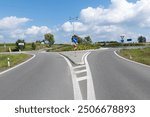 The roundabout road aerial view that newly developed. Summer sunny day. Roundabout on suburban road. Universal road photo. Road in agricultural fields landscape adn small town.